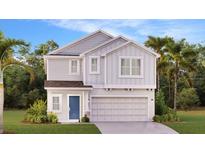 Two-story home with gray siding, two-car garage, and landscaping at 4738 Guinep Ln, Kissimmee, FL 34758