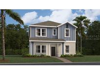 Two-story home with blue siding, white trim, and a landscaped front yard at 3129 Zuni Rd, St Cloud, FL 34771