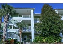 Two-story building exterior with stairs and lush landscaping at 606 Gran Bahama Boulevard # 29-606, Davenport, FL 33897