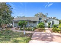 Ranch style home with a green exterior, landscaping, and a long driveway at 151 Pine St, Babson Park, FL 33827