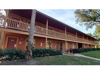 Two-story building with balconies and landscaping at 3200 River Ranch Blvd # 204, River Ranch, FL 33867