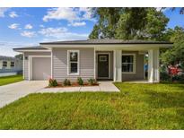 Newly built home with front porch and landscaping at 2834 Eaton Ave, Eaton Park, FL 33840