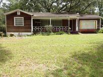 Older home with wood siding and a small front porch at 217 Catalonia Ave, De Leon Springs, FL 32130