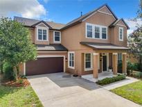 Two story house with brown exterior and brown garage door at 319 Ravenshill Way, Deland, FL 32724