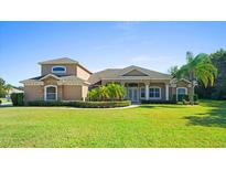 Two-story home with stone accents and manicured lawn at 5994 Seminole Woods Dr, Port Orange, FL 32127