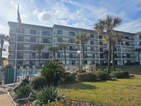 Three-story building with pool and landscaping at 2700 Ocean Shore Blvd # 111, Ormond Beach, FL 32176