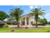 Grand two-story home with stone accents and palm trees at 1978 Country Club Dr, Port Orange, FL 32128