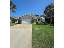 Single-story home with driveway and landscaping at 833 E 22Nd Ave, New Smyrna Beach, FL 32169