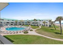 Community pool, lush landscaping, ocean views at 815 Ocean Shore Blvd # U1B, Ormond Beach, FL 32176