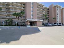 Sandcastle North building exterior with ample parking at 4435 S Atlantic Ave # 414, Ponce Inlet, FL 32127