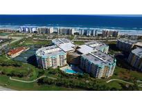 Aerial view of coastal condo community with pool and tennis courts at 4650 Links Village Dr # B307, Ponce Inlet, FL 32127