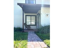 Front entry with brick walkway and covered porch at 322 Canal Rd # A1, Edgewater, FL 32132