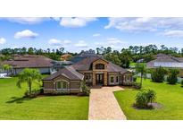 Luxury home with a large lot and a brick driveway at 87 Tomoka Ridge Way, Ormond Beach, FL 32174