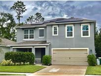 Two-story house with solar panels and a two-car garage at 234 Duke Dr, Deland, FL 32724