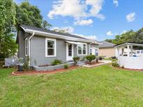 Gray house with a well-manicured lawn and landscaping at 2300 Calloway Dr, Orlando, FL 32810