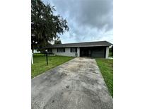 Ranch style home with a long driveway at 133 Debary Dr, Debary, FL 32713