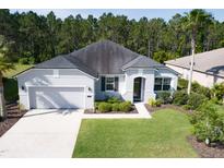 Single-story home with two-car garage and landscaped yard at 117 Boysenberry Ln, Daytona Beach, FL 32124