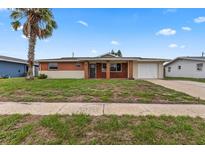 Single story home with brick facade and lawn at 22 Morning Star Ave, Ormond Beach, FL 32176