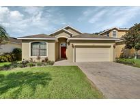 One-story house with a two-car garage, landscaping and a brick driveway at 1512 Loughton St, Deland, FL 32720