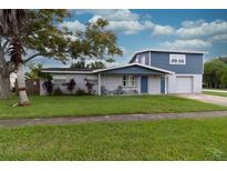 Ranch-style home with blue siding and garage at 2100 Brian Ave, South Daytona, FL 32119