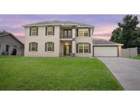 Two-story house with a large yard and attached garage at 2291 Henry Ln, Deltona, FL 32738