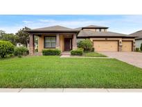 Two-story house with a landscaped lawn and two-car garage at 733 Stone Oak Dr, Sanford, FL 32771