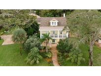 Two story yellow house with lush landscaping at 900 Riverside Dr, Daytona Beach, FL 32117