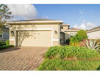 House exterior with a two-car garage and a brick paved driveway at 1401 Palisades Ln, Deland, FL 32724