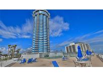Oceanfront high-rise building with tennis courts and seating area at 2625 S Atlantic Ave # 24Nw, Daytona Beach, FL 32118