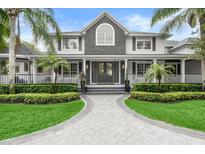 Two-story home with gray and white exterior, landscaping, and a walkway at 4 Broad Creek Cir, Ormond Beach, FL 32174