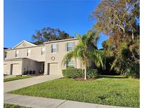 Two story townhome with attached garage, landscaping, and palm tree at 1630 Primo Ct, Daytona Beach, FL 32117
