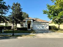 One-story house with attached garage and landscaping at 211 Foxglove Way, Deland, FL 32724