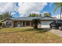 Brick house with attached garage and landscaping at 1020 Hanford Dr, Deltona, FL 32738
