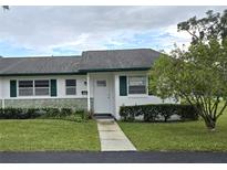 Front view of a charming house with green shutters and a neatly landscaped yard at 201 N Hill Ave # 150, Deland, FL 32724
