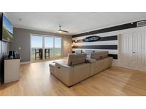 Living room with sectional sofa, ocean view, and hardwood floors at 2300 N Atlantic Ave # 1502, Daytona Beach, FL 32118