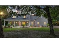 Two-story house with a porch and well-manicured lawn at 5711 John Anderson Hwy, Flagler Beach, FL 32136