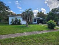 Single-story home with a palm tree in the front yard at 1777 Oasis Ave, Deltona, FL 32725