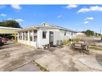 Exterior view of commercial building with outdoor seating at 2490 N Woodland Blvd, Deland, FL 32720