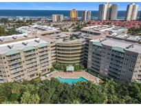 Aerial view of an apartment building with a pool and ocean view at 4 Oceans West Blvd # 108B, Daytona Beach, FL 32118