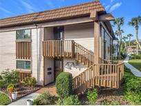 Exterior view of condo with private entrance and wooden staircase at 600 N Boundary Ave # 106D, Deland, FL 32720