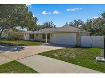 Single-story house with attached garage and driveway, surrounded by green lawn at 552 Nardello Dr, Deltona, FL 32725