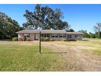 Single story home with a large front yard and mature trees at 102 Marta Rd, Debary, FL 32713