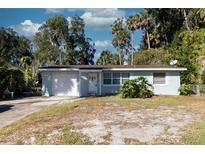 Light blue house with a white garage door and mature trees at 1068 North St, Daytona Beach, FL 32114