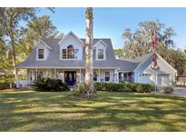 Two-story house with a large front yard, porch, and detached garage at 2236 River Ridge Rd, Deland, FL 32720