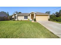 Charming house with a well-manicured lawn and driveway at 2471 Oleander Rd, Deland, FL 32724