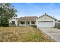 Single-story home with attached garage and well-maintained lawn at 274 Sunrise Blvd, Debary, FL 32713