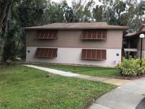 Two-story condo building with wood shutters and grassy yard at 150 Wax Myrtle Woods Ct # 9D, Deltona, FL 32725