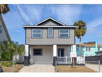 Newly constructed two-story home with gray siding and a white porch at 311 Ora St, Daytona Beach, FL 32118