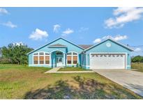 Charming light blue house with a two-car garage and spacious yard at 3190 Lori Ct, Deltona, FL 32738