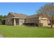 One-story house with brown siding, a screened porch, and lush lawn at 4859 Nw 35Th Lane Rd, Ocala, FL 34482